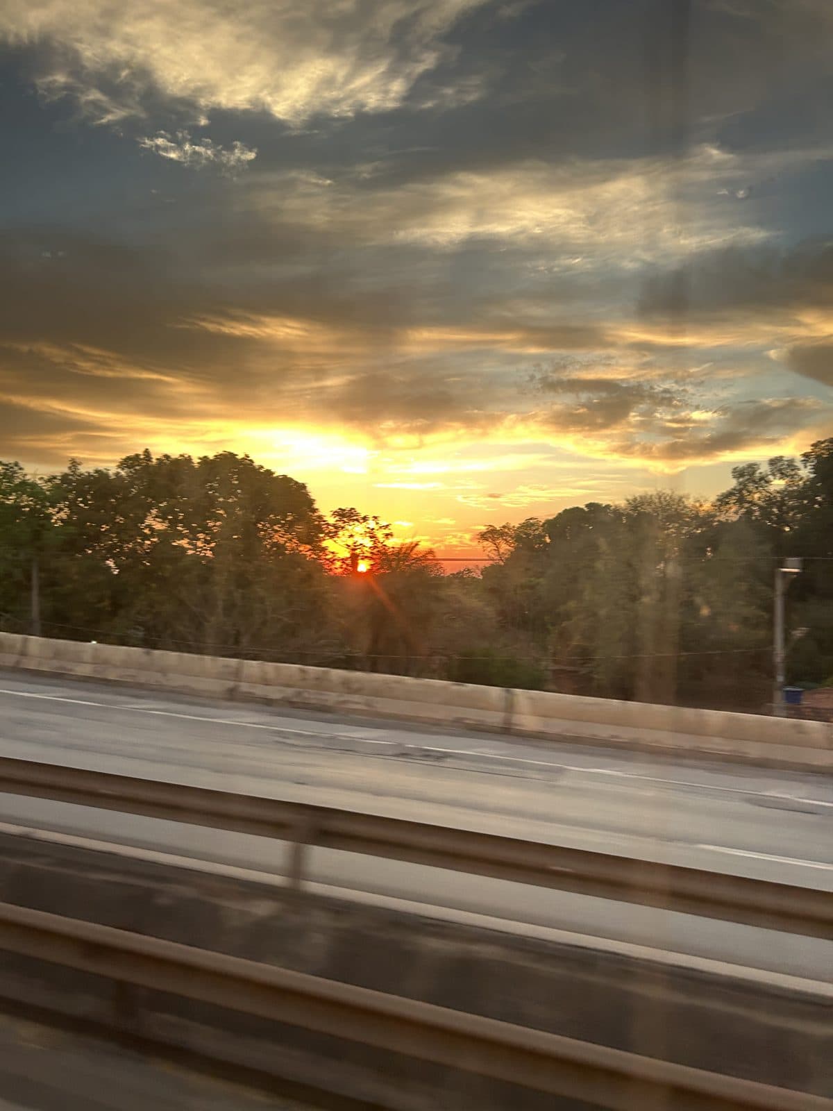 Sunset over the road, seen through the bus window, on the way to Florianópolis.